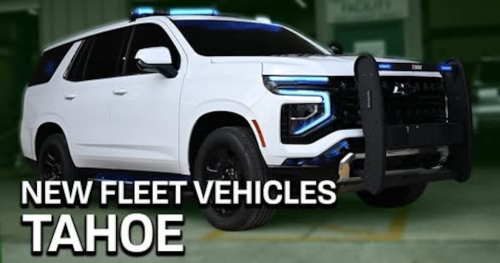 White Chevrolet Tahoe police SUV with light bar and push bumper, labeled "NEW FLEET VEHICLES TAHOE
