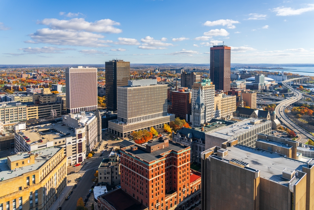 Aerial cityscape showing downtown skyline with office buildings and waterfront in background