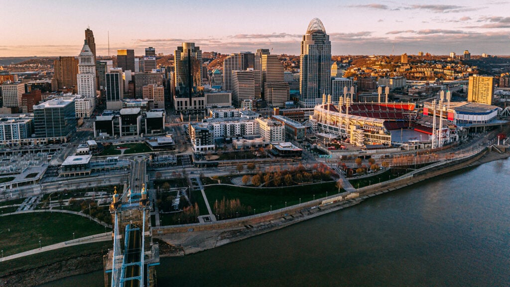 Aerial view of Cincinnati skyline at sunset with river waterfront and downtown buildings