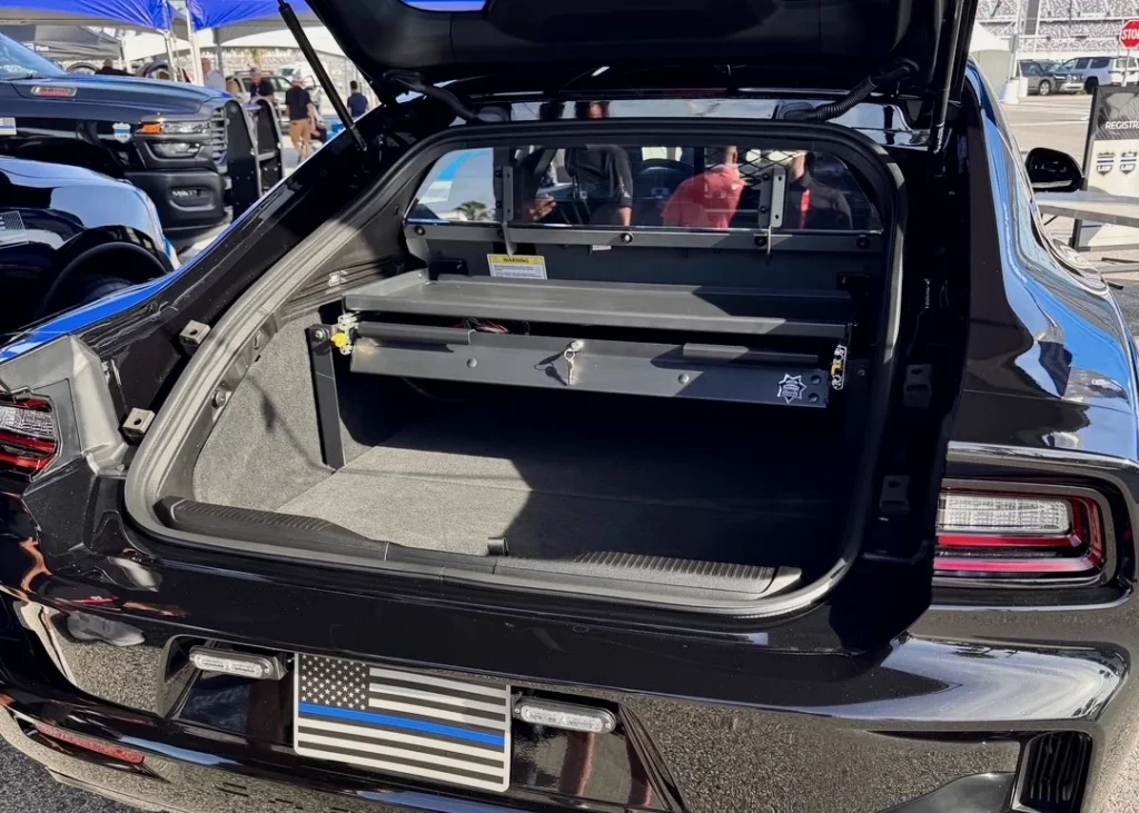 Open liftback of the Dodge Charger PPV prototype showing a divider and slide-out equipment tray in the cargo area.