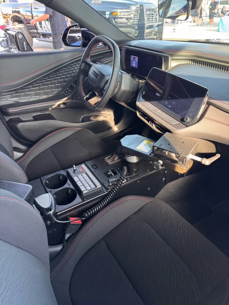 Front cabin of the Dodge Charger PPV prototype showing an equipment console with siren controls, cup holders and a laptop mount.