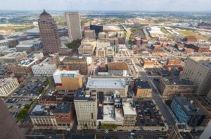 Aerial view of downtown urban area with parking lots and mixed-use buildings