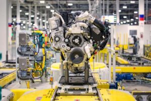 Engine assembly mounted on yellow production fixture in automotive manufacturing facility