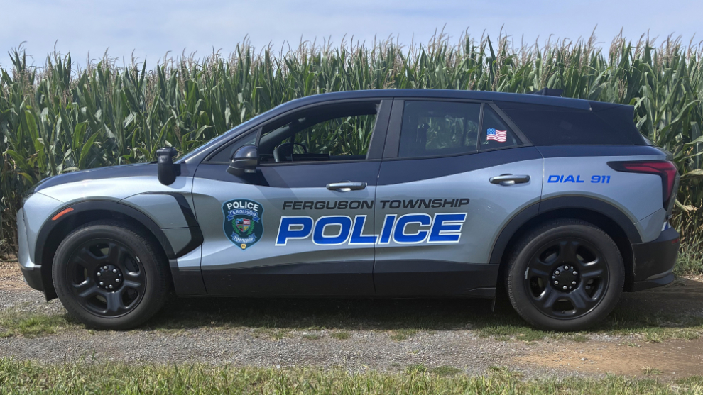 Ferguson Township Police electric patrol vehicle parked beside cornfield