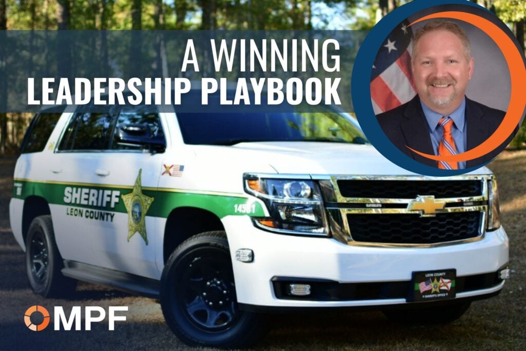 Leon County Sheriff's white Chevrolet Tahoe police vehicle with "A Winning Leadership Playbook" text and male professional headshot