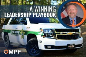 Leon County Sheriff's white Chevrolet Tahoe police vehicle with "A Winning Leadership Playbook" text and male professional headshot