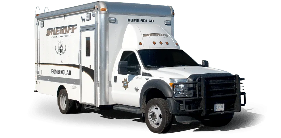 White and silver sheriff bomb squad vehicle with black grille and protective cage