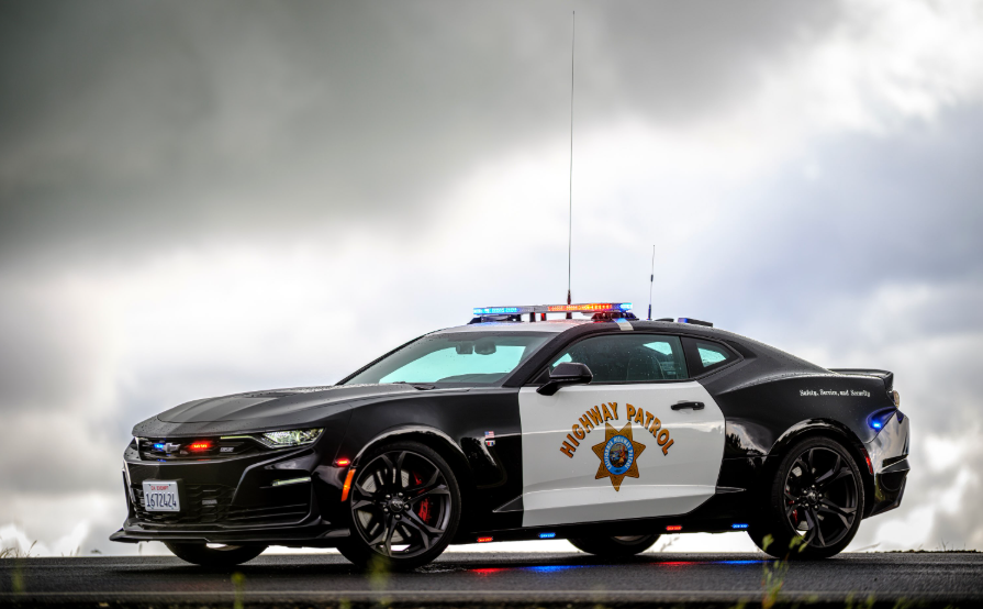 California Highway Patrol Chevrolet Camaro police car against cloudy sky