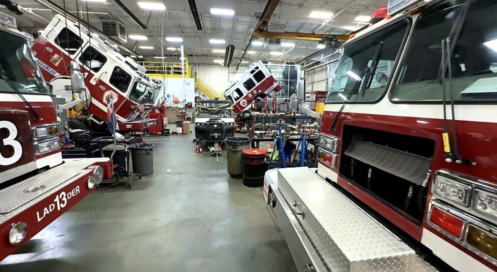 Fire engines and a ladder truck in service bays at the City of Aurora fleet shop