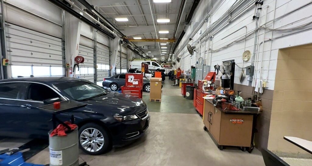 A sedan on a lift and technician toolboxes along a light-duty service aisle at the City of Aurora fleet shop