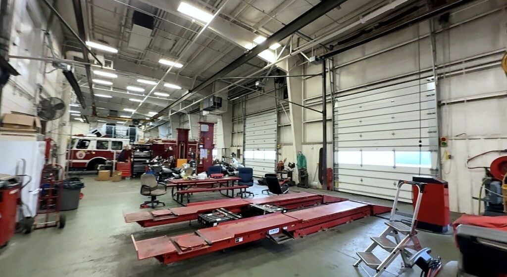 An alignment lift with a fire engine in the background at the City of Aurora fleet shop