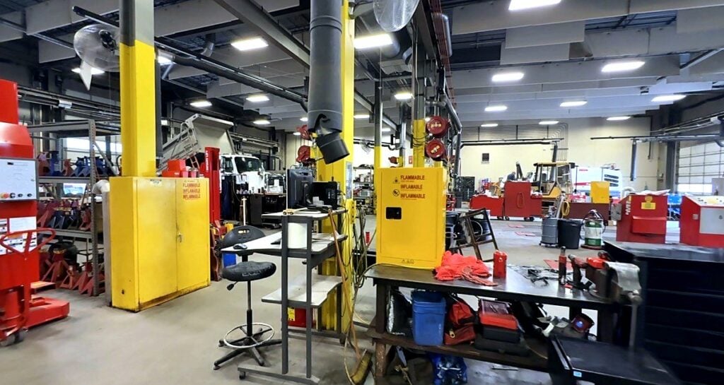 Yellow flammable-storage cabinets and a workbench on the heavy-duty shop floor at the City of Aurora fleet shop