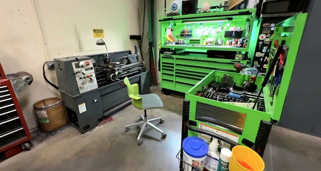 A metal lathe beside a lit green toolbox in the City of Aurora fleet shop