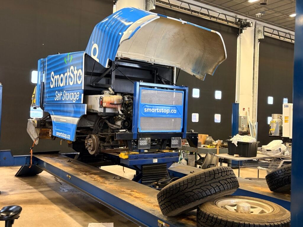 SmartStop self-storage delivery truck on hydraulic lift platform in warehouse facility