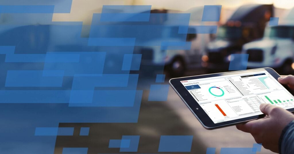 Hand holding tablet displaying fleet analytics dashboard with charts and performance metrics outdoors