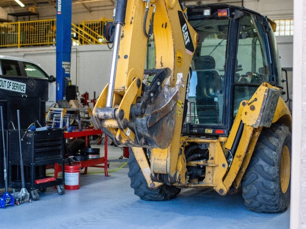 Town of Apex backhoe parked inside the fleet shop