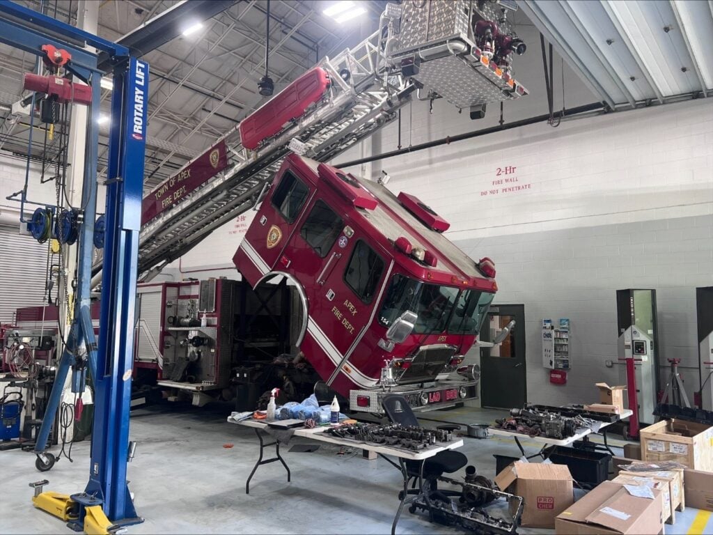 Fire truck raised on a lift in the Town of Apex fleet shop