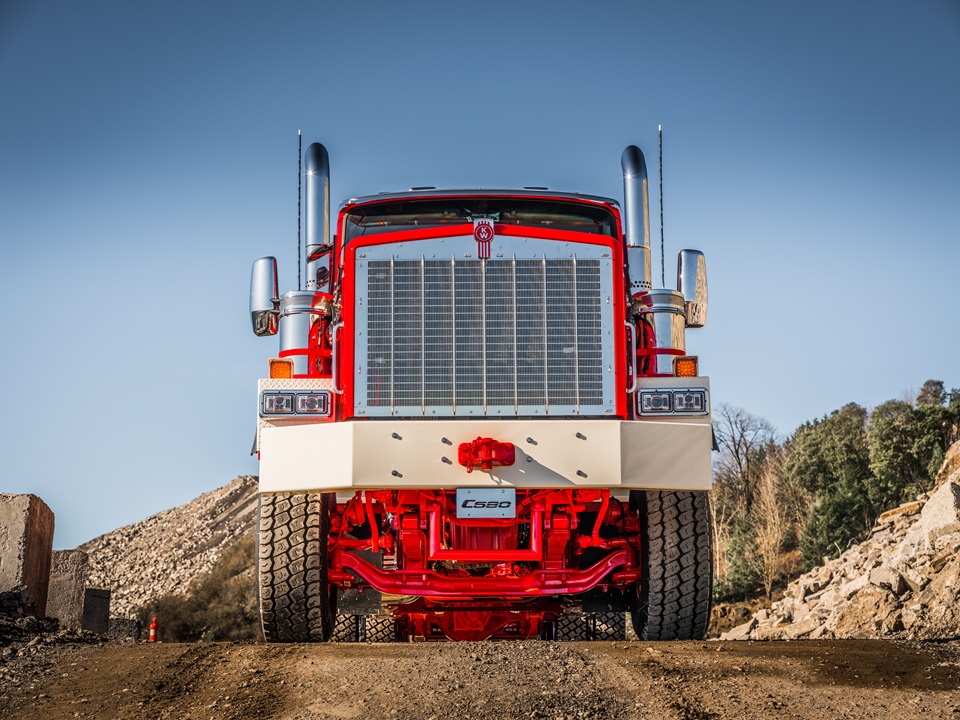 Red Peterbilt semi truck photographed head-on at gravel mining or quarry site