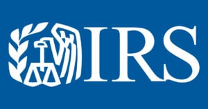 IRS logo on blue background with eagle, scales, and laurel wreath