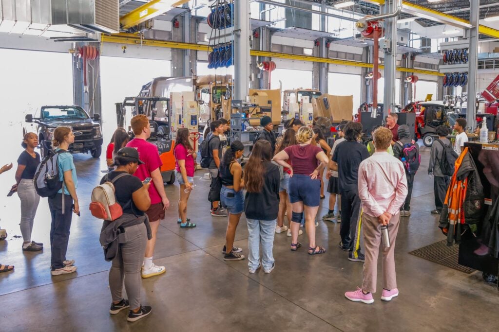 Mark Vander Waal leads high school students on a tour of the Madison fleet shop