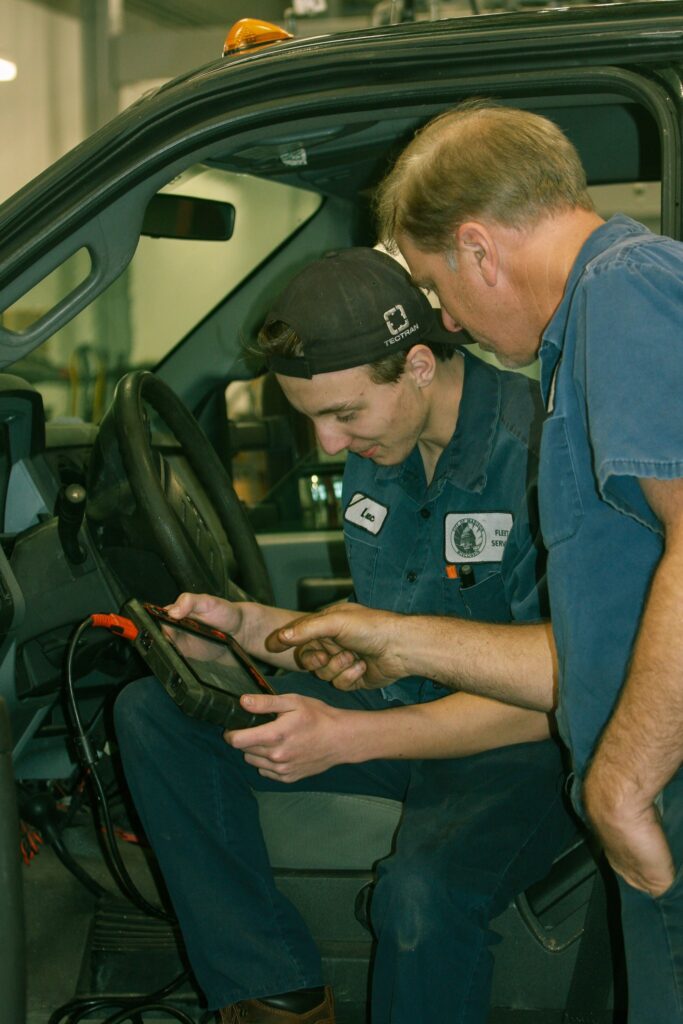 Apprentice Luc Meuzelaar reads diagnostic codes on a truck with mentor Duane Hammersley
