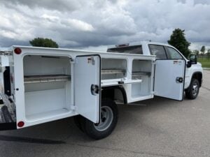 Monroe ServicePRO XP S-Series aluminum service body with compartment doors open on a pickup chassis