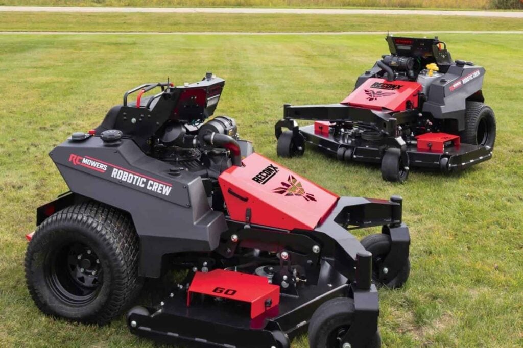 Two RC Mowers RECONX autonomous mowers on a grass field