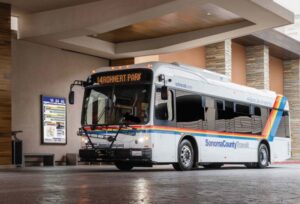 Sonoma County Transit bus parked in covered station with route sign and schedule board visible