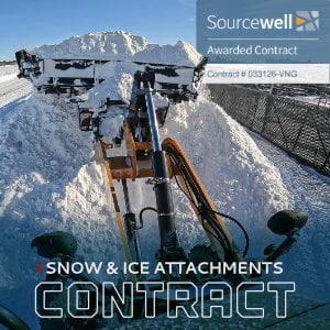 Snow plow attachment mounted on truck bed in snowy mountain landscape